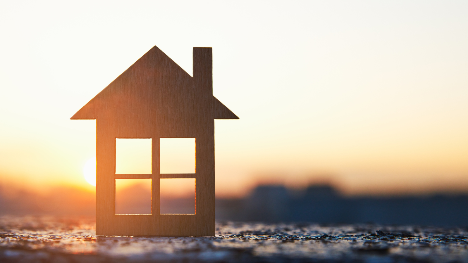 A stock image of a house in a sunset. 