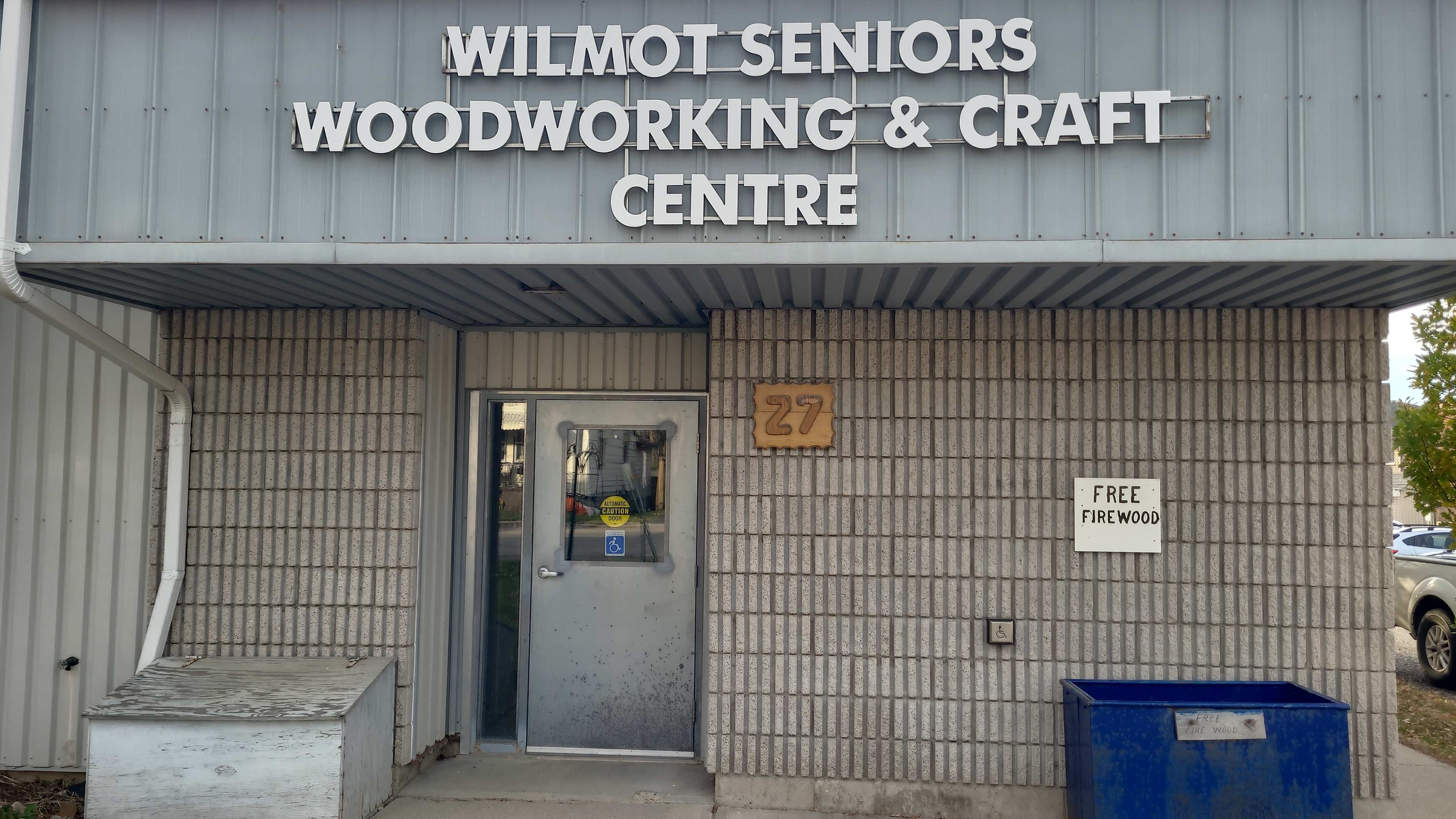 The front of a building that says "Wilmot Seniors Woodworking and Craft Centre".