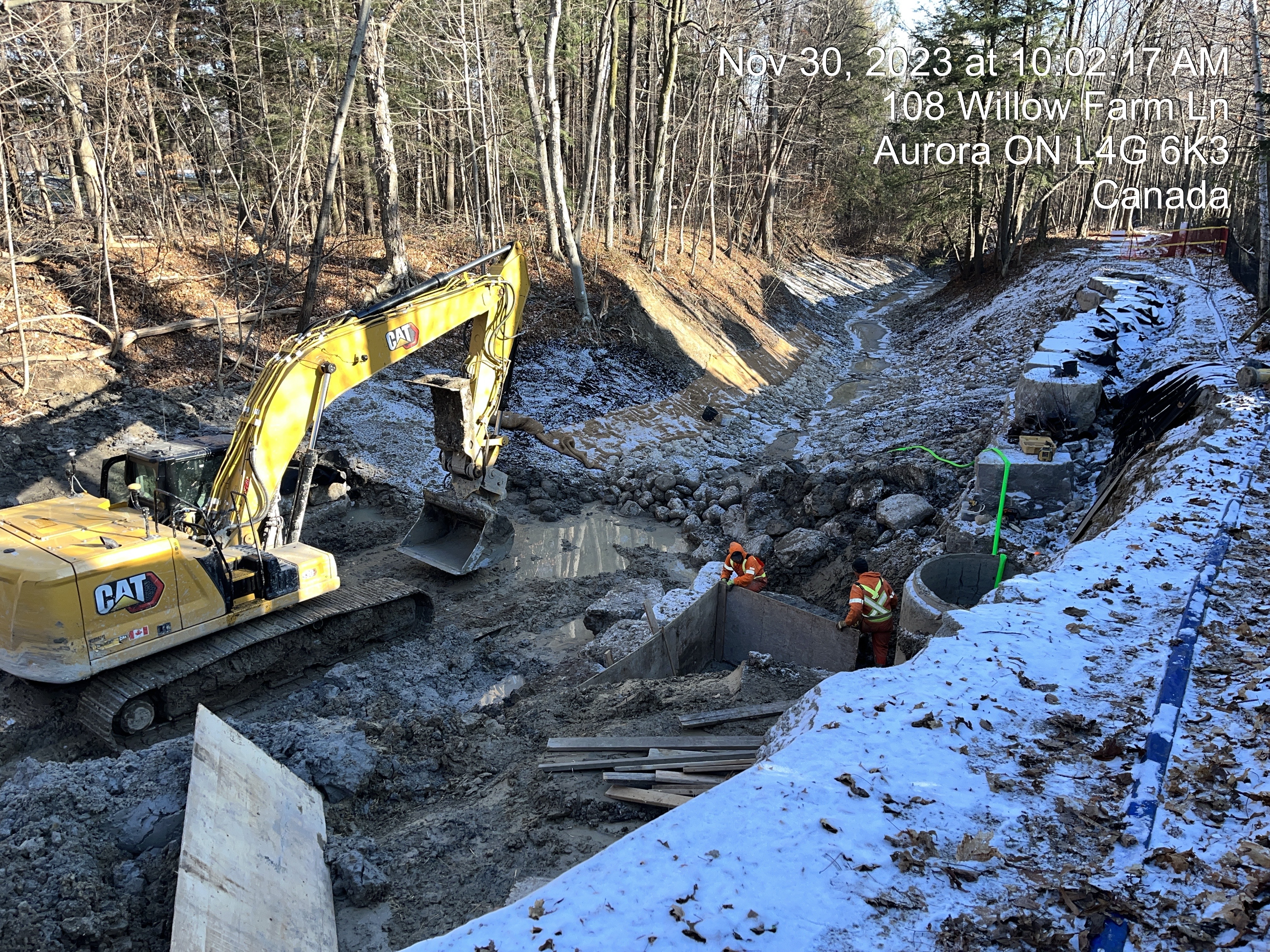 Construction equipment digging up part of a stream bed