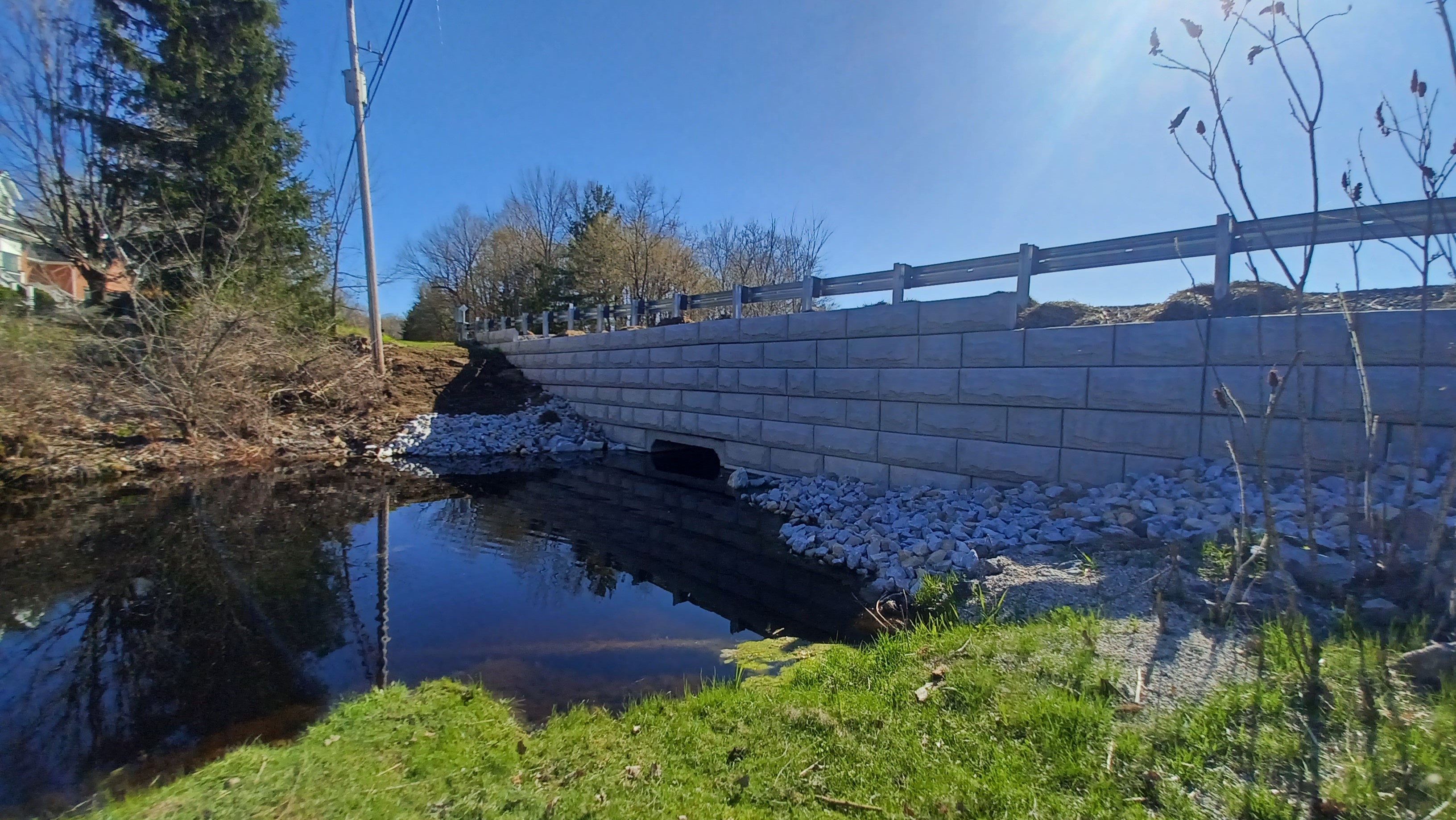 A wide shot of the culvert and bridge on a sunny day