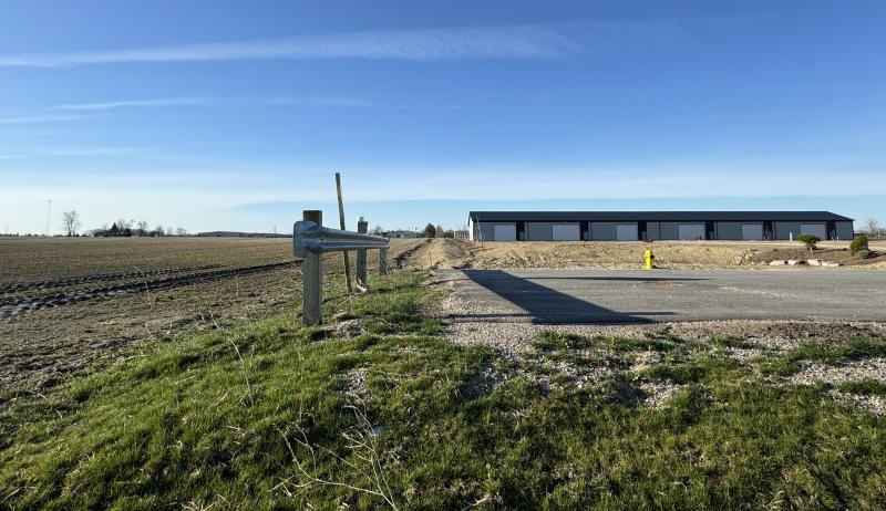 A wide shot of a road and the surrounding buildings.