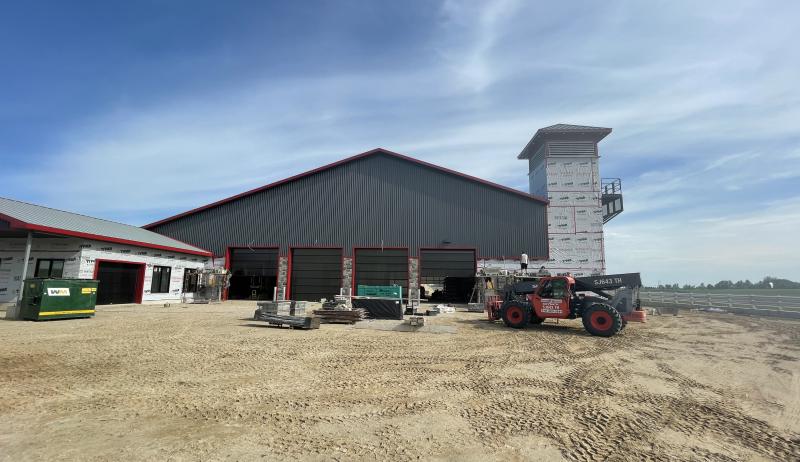 Construction of the new fire hall, with trucks parked in front of the hall.