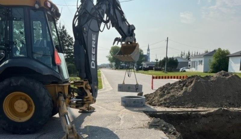 Town crews digging up the manhole