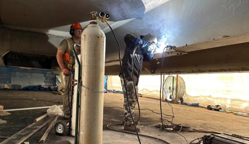 Town crews working on the supports underneath the bridge