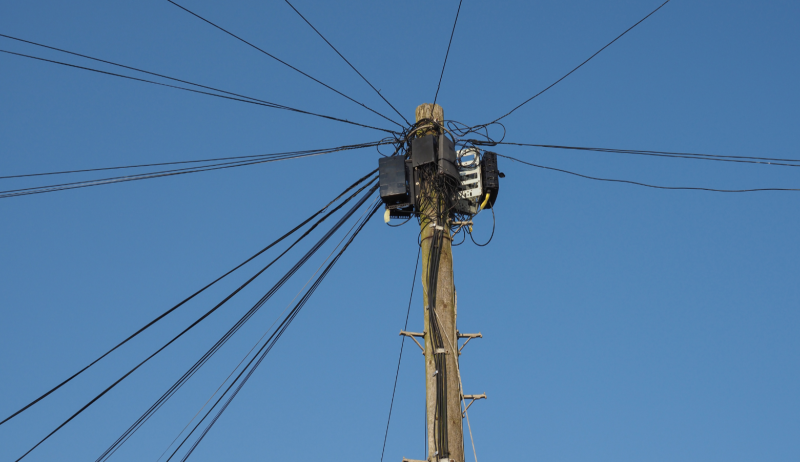 Fibre cables running from a post to nearby homes and businesses