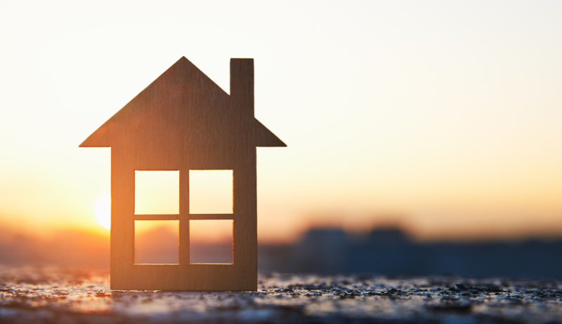 A stock image of a house in a sunset. 