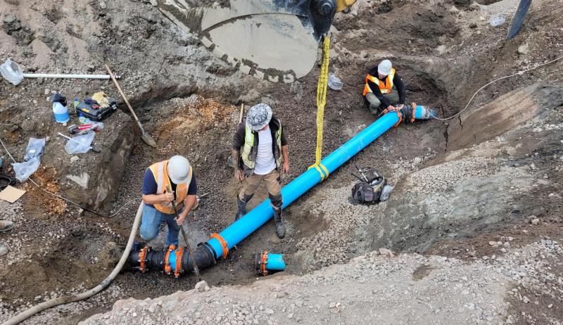 Construction workers working on a pipe