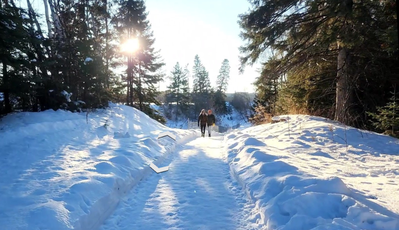 A snow covered trail on a sunny day.