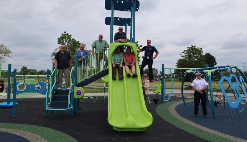City staff posing on play structure