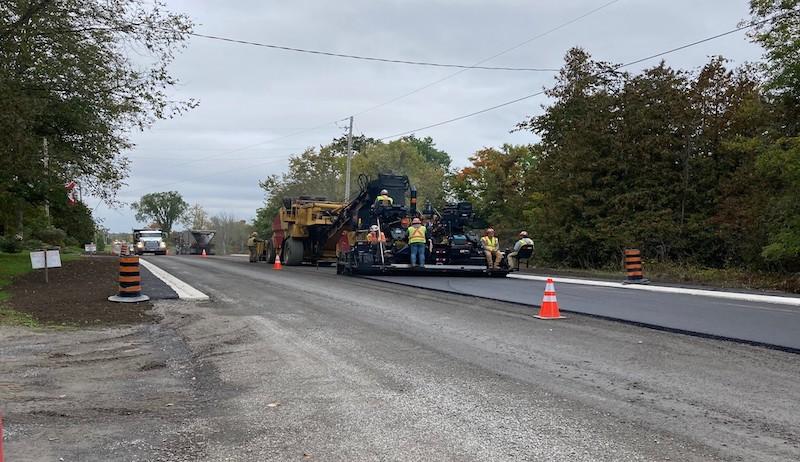 Construction equipment works on a County road in Lennox and Addington. 