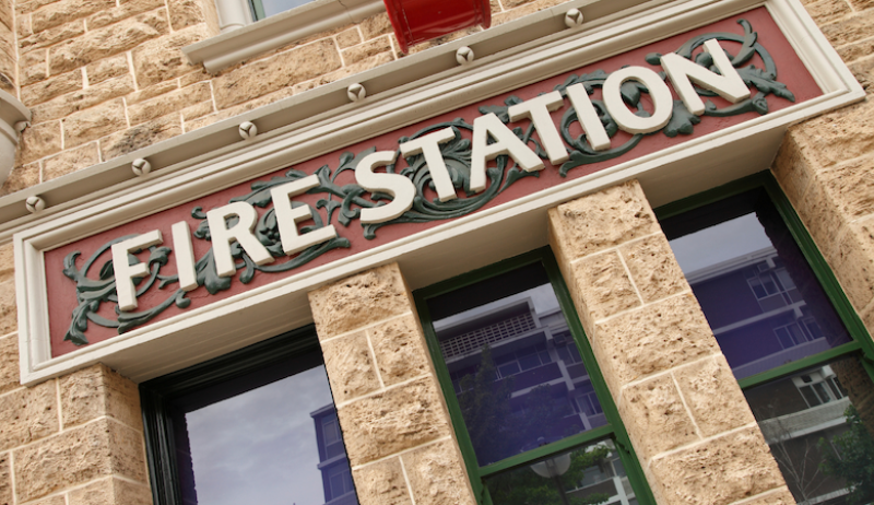 A photo of the outside of a fire station. 