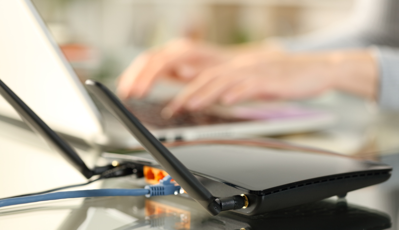 Stock image of person typing on a laptop. 