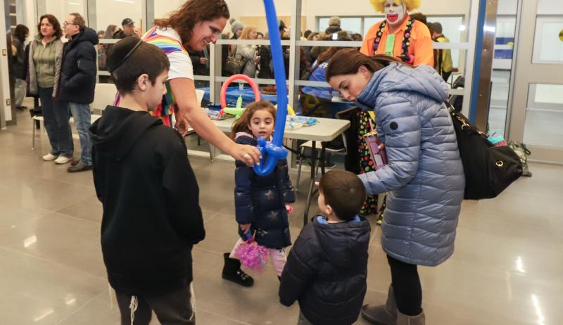 Children receive a balloon at the grand re-opening of the Garnet A. Williams Community Centre in Vaughan. 